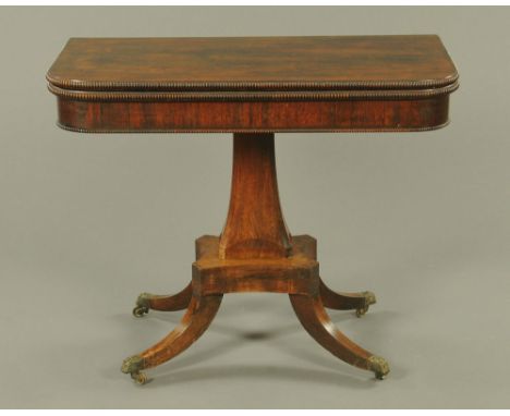 A Regency rosewood turnover top card table, with moulded edge and green baize lined playing surface with faceted column and d