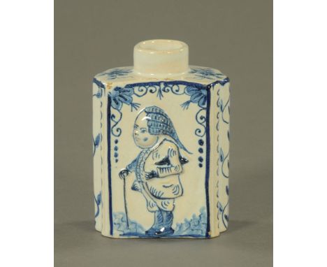An 18th century Dutch Delft tea caddy, relief moulded with figures.  Height 11 cm.