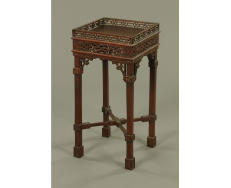 A Chippendale style mahogany kettle stand, with fretwork frieze and raised on legs of square section with spade feet.  Height
