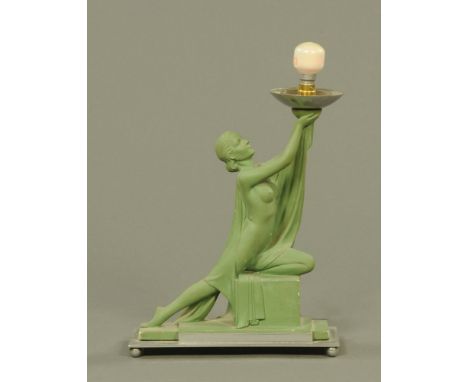 An Art Deco green painted plaster table lamp, stamped RD 817178 243 and raised on a chrome plated plinth with ball feet.  Hei