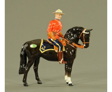 A Beswick porcelain Mountie figure.  Height 20 cm. CONDITION REPORT: The head of the Mountie has been off and restored.  Ther