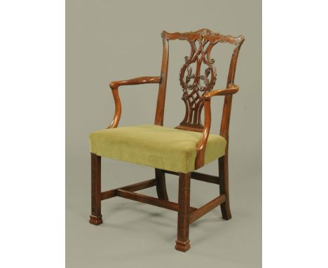 A Chippendale style armchair, with splat back stuffover seat and blind fretwork carved front legs.