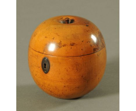 A Georgian fruitwood "Apple" tea caddy, with brass lock escutcheon and lead lined interior.  Height +/- 12 cm, diameter 11.5 