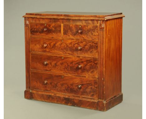 An early 19th century mahogany chest of drawers, with caddy top above two short and three long drawers with wooden knob handl