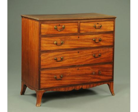 A George III mahogany chest of drawers, with applied moulded edge above two short and three long graduated drawers with brass