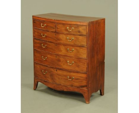 A 19th century mahogany bowfronted chest of drawers, two short and four long with brass drop handles with shaped apron beneat