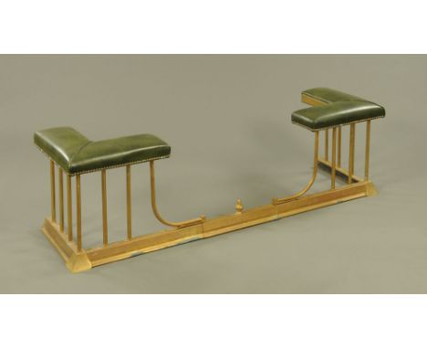 A brass club fender, with green leatherette upholstered corners.  External length extended 154 cm, but will reduce by a furth