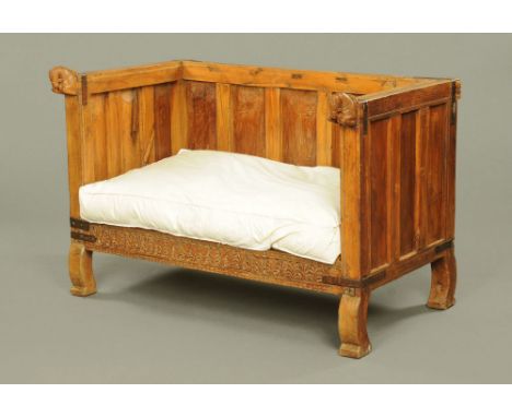 An antique Indian daybed, with horse head terminals, with loose seat cushion and raised on shaped legs.  Height 89 cm, width 