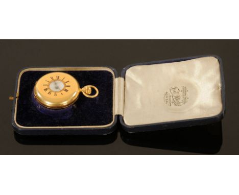A ladies 18 k gold half hunter keyless lever pocket watch, No. 354820.  4 cm diameter, contained in a blue leather cover case