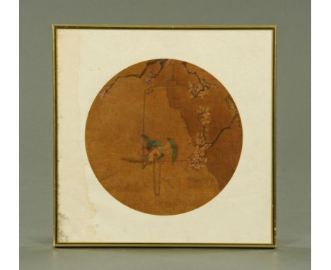 A Chinese painting on silk of a parrot, circular. Diameter 26 cm. CONDITION REPORT: This painting appear to have suffered bot