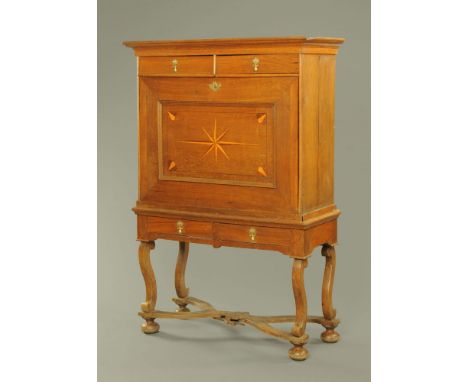 A William and Mary secretaire cabinet, the top half with two drawers above the secretaire cupboard, the base fitted with two 