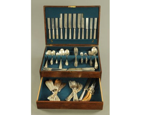 An oak canteen containing a quantity of silver plated cutlery, various types and with horn handled steel and carving fork.