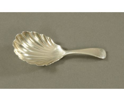A silver shell shaped caddy spoon, London 1907, maker George Jackson and David Fullerton.