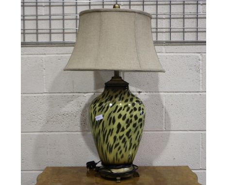 An Uttermost Malawi cheetah print table lamp. All electrical items in this lot have been PAT tested for safety and have passe