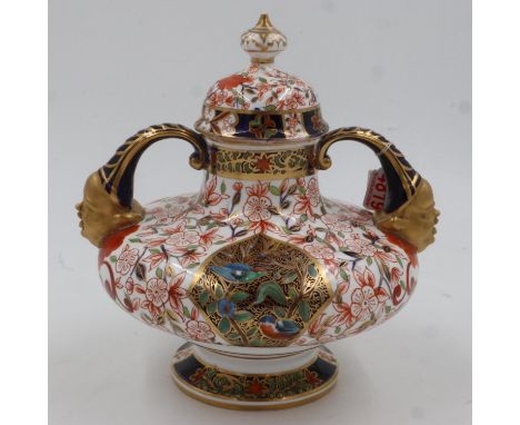 Late 19th century Royal Crown Derby covered urn of squat form with mask handles profusely decorated with designs of birds and