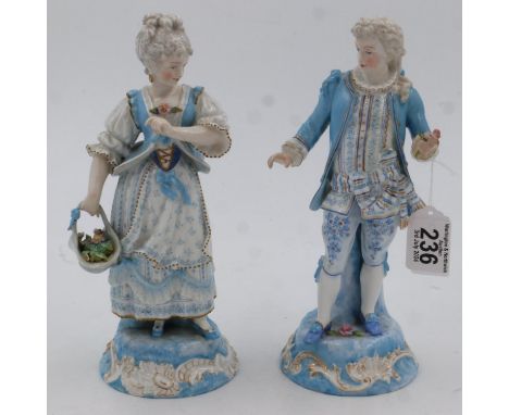 A pair of 19th century continental ceramic figures, lady with basket of flowers and gentleman holding single flower, each H:2