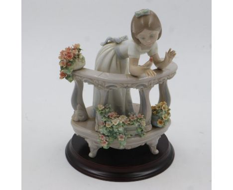Lladro figure of a girl leaning on a balcony, H:23cm, some losses to petals. UK P&amp;P Group 3 (£30+VAT for the first lot an