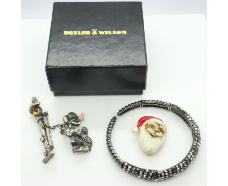 Three pieces of Butler &amp; Wilson costume jewellery, including an enamelled Santa brooch, a Poodle &amp; Lamppost brooch an