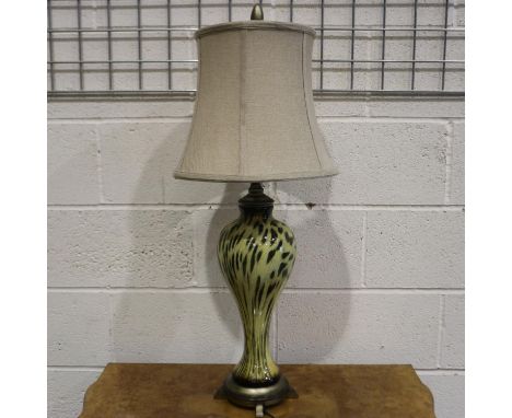 An Uttermost Malawi cheetah print table lamp. All electrical items in this lot have been PAT tested for safety and have passe