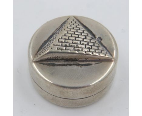 Egyptian silver circular pill box, the cover relief decorated with the form of a pyramid, D: 25 mm, 16g. UK P&amp;P Group 1 (