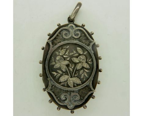 A large Victorian silver oval locket, floral decorated in relief, unmarked, drop L: 60 mm (including bale). UK P&amp;P Group 