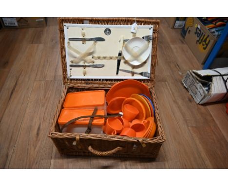 Vintage wicker picnic basket with plastic boxes and cutlery 