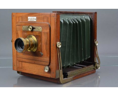 A Mahogany and Brass Tailboard Camera, sold by J. Ashford 179 Aston Road Birmingham, body G, tarnishing to brass, with green 