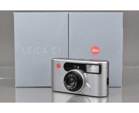 A Leica C1 Compact Camera, silver, shutter working, flash working, self timer working, body F, top & bottom plate tacky, with