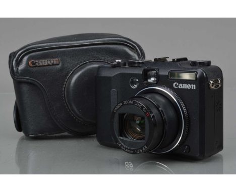 A Canon G9 Digital Camera, powers on, shutter working, flash working, display working, body G, elements G-VG, with two batter
