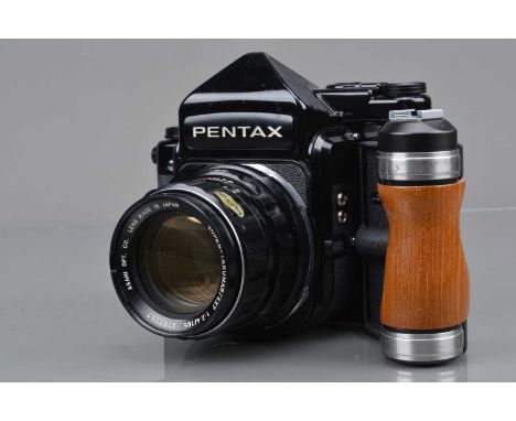 A Pentax 67 Camera, serial no 4216810, shutter working, body G, some scratches bellow shutter speed dial front edge, light sc