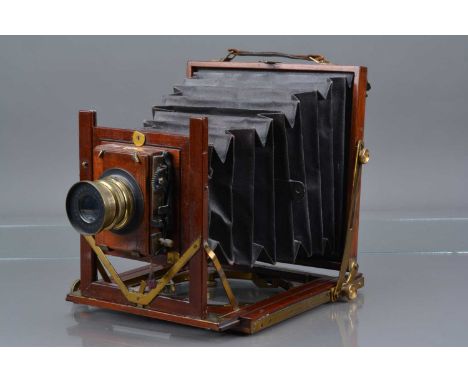 A Mahogany and Brass Half Plate Camera double extension, body G, some tarnishing to brass, bellows P, with Beck f/8 Symmetric