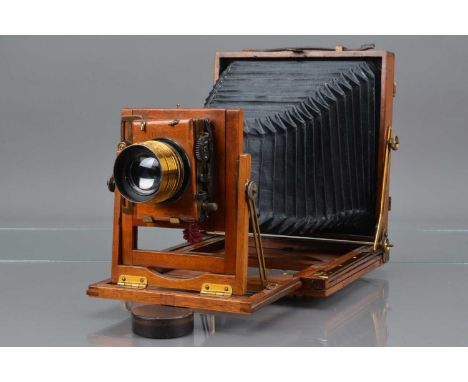 A Mahogany and Brass Half Plate Camera, double extension, body G, some tarnishing to brass, bellows G, with Taylor  & Hobson 