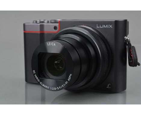 A Panasonic Lumix TZ100 Digital Camera, silver, powers up, shutter working, flash working, display working, touch screen work