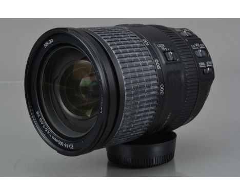 A Nikon DX AF-S Nikkor 18-300mm f/3.5-5.6G ED VR Lens, serial no 72112137, auto focusing working, barrel G-VG, some fading to