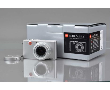 A Leica D-LUX 2 Digital Camera, silver, shutter working, flash working, self timer working, display working, body VG, with DC