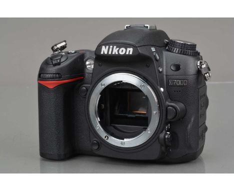 A Nikon D7000 DSLR Camera Body, serial no 6380576, shutter working, flash working, display working, body G-VG, with battery &