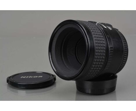 A Nikon AF Micro Nikkor 60mm f/2.8D Lens, serial no 3046918, auto focusing working, barrel G, paint scratch to outer edge of 