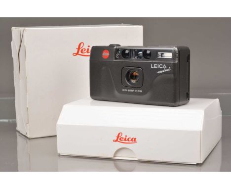 A Leica Mini Compact Camera, shutter working, flash working, self timer working, data back untested, no battery, body G, with