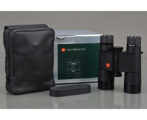 A Pair of Leica 7x35 Trinovid 40714 Binoculars, black, made in Portugal, body VG, elements VG, with rear cap, case, strap, ma
