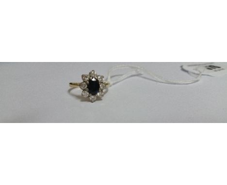 An 18ct Diamond and Sapphire Ring.