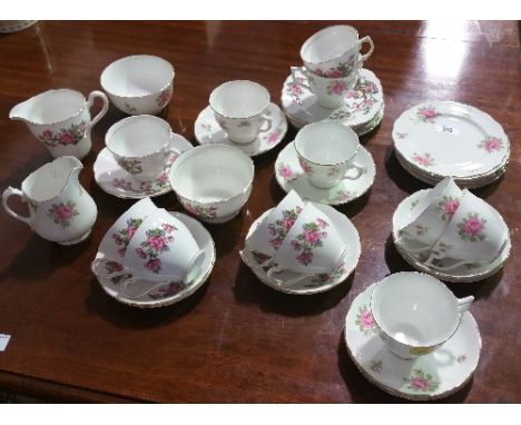 A Melba Chine Six Place Tea Service; with pink rose detail, including milk jug and sugar bowl etc.