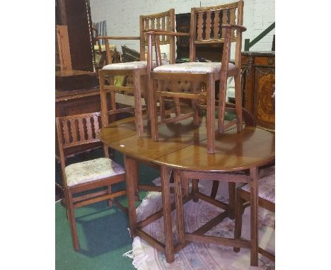 A Lovely Set of Ercol Furniture; to include a small drop leaf table along with four dining chairs.