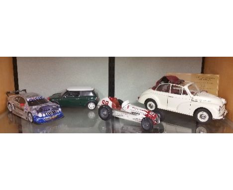 A Limited Edition Model of a Mini along with a Mini Cooper, a Mercedes and a Vintage Racing Car.