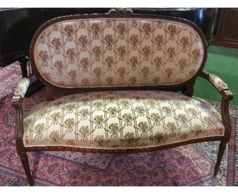 A Beech Framed Upholstered Sofa with serpentine front seat on turned and fluted supports.