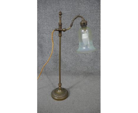 A late Victorian brass adjustable desk lamp, with an etched opalescent Vaseline glass shade, on a circular footed base. H.60 