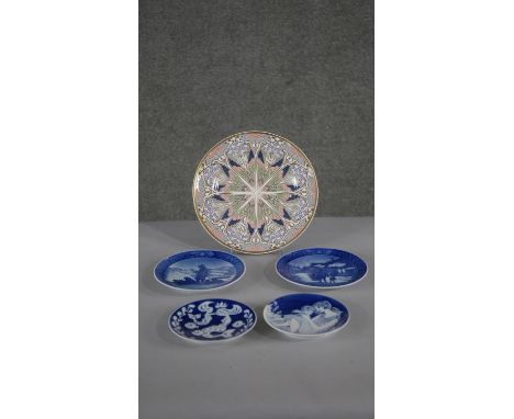 A collection of porcelain plates, including Royal Copenhagen blue and white commemorative plates and a Liberty design plate, 
