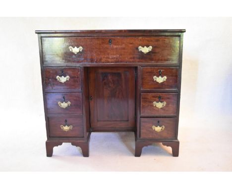 A 19th century mahogany kneehole desk with central drawer above panel cupboard flanked by pedestal drawers on bracket feet. H