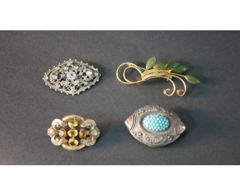 A collection of four brooches, including a Citrine set gold filled brooch, a Jade foliate brooch and two other brooches. 