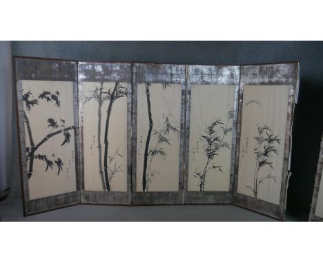 A Chinese six fold screen, each panel painted in black ink depicting bamboo, each with Chinese characters in black, with a re