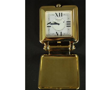 A boxed ‘Happy Day’ travel clock, by Chopard in maker’s case. Dial, case signed Chopard, no. 51/6677-23, 919245. Metal unmark